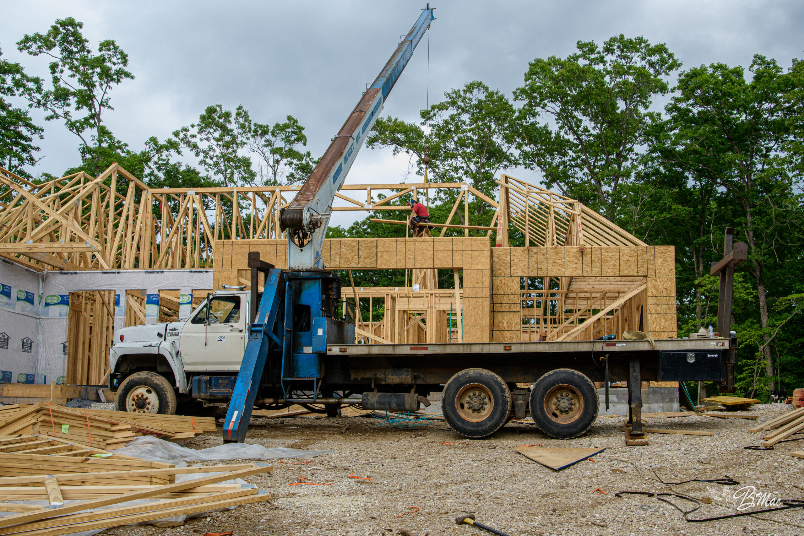 Cloke Custom Homes framing crew installing roof trusses on a Lake of the Ozarks build