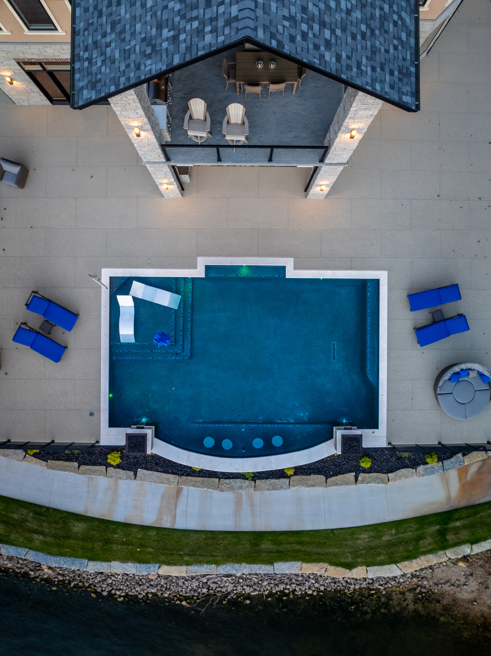 Aerial view of custom pool and patio at Cloke Custom Homes lakefront build