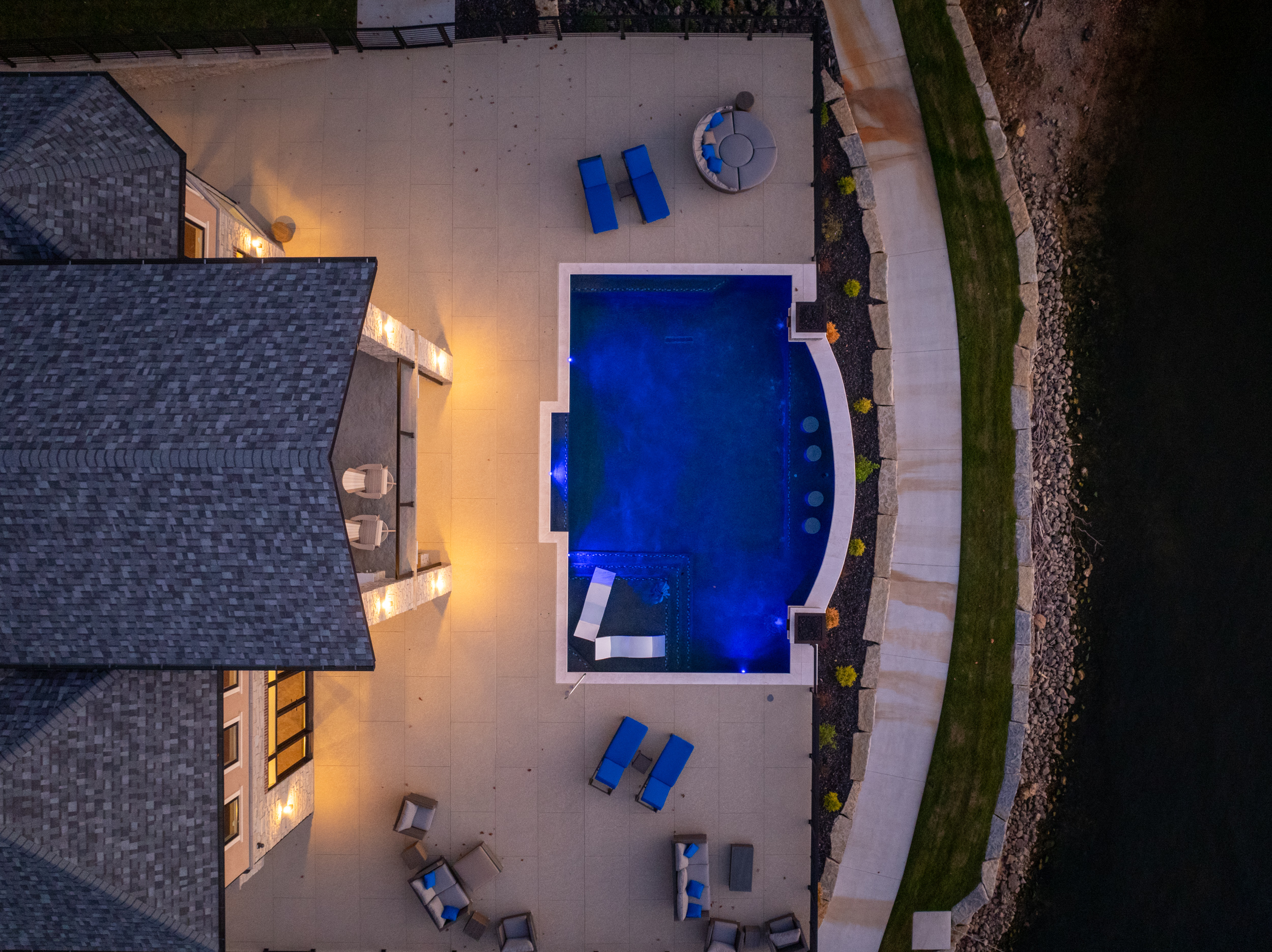 Cloke Custom Homes single-level lakefront build at dusk, wide view