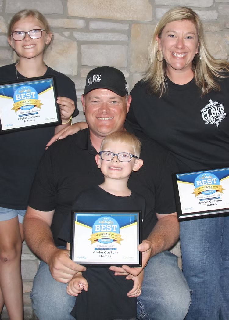 Charles Cloke and family holding 2023 Best of the Lake winner awards — Home Builder, General Contractor, Custom Woodworking