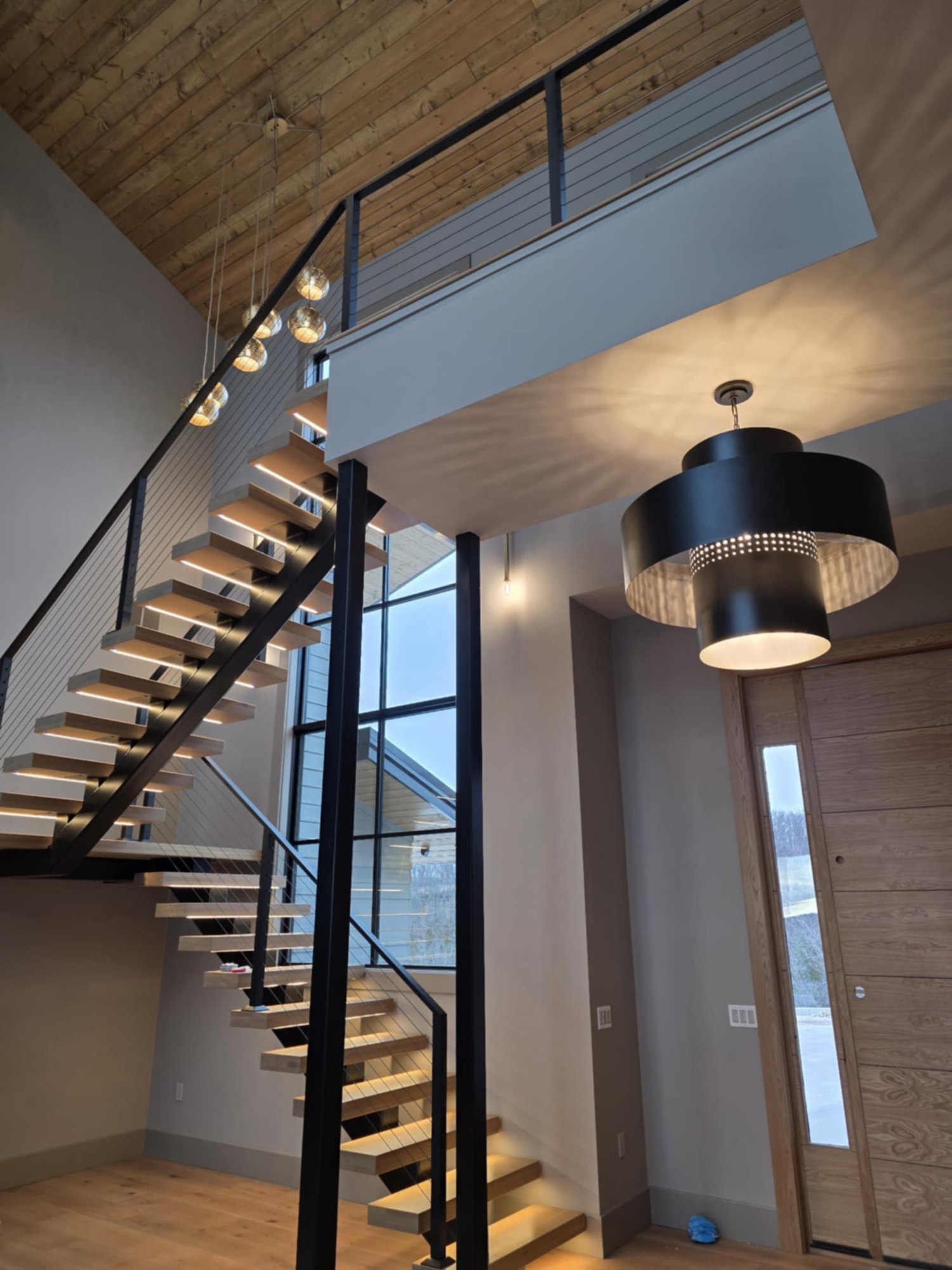Floating cable-rail staircase in contemporary lakeview home by Cloke Custom Homes