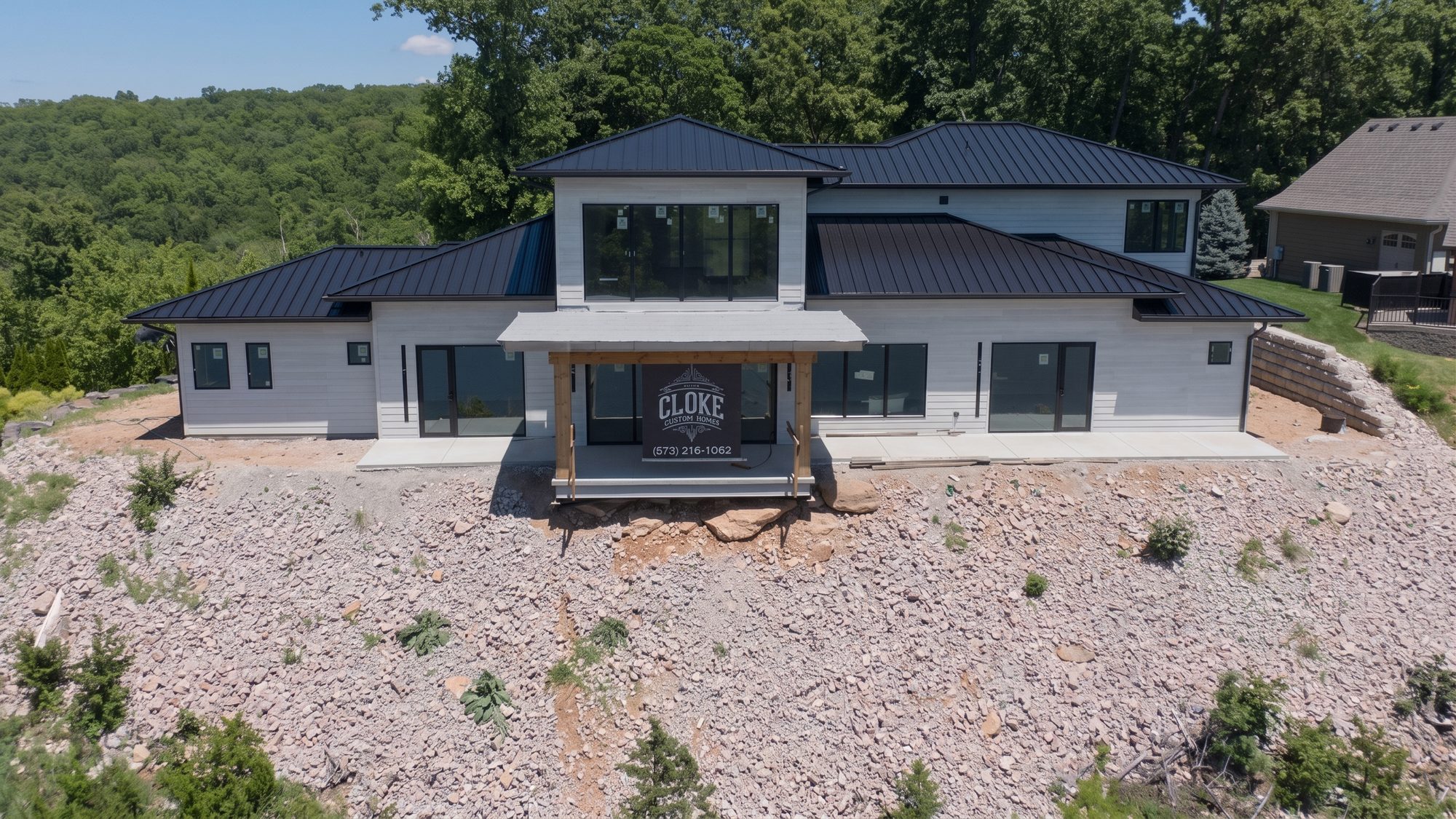 Modern Cloke Custom Homes build perched on a rocky cliffside at the Lake of the Ozarks